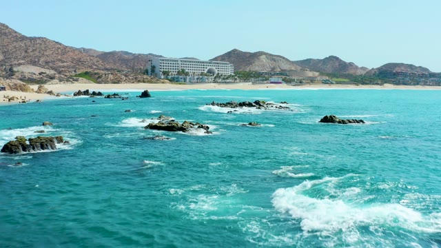 MARQUIS LOS CABOS MEXICO-2021: Coastal Rocks and Turquoise Waves near Sandy Beach