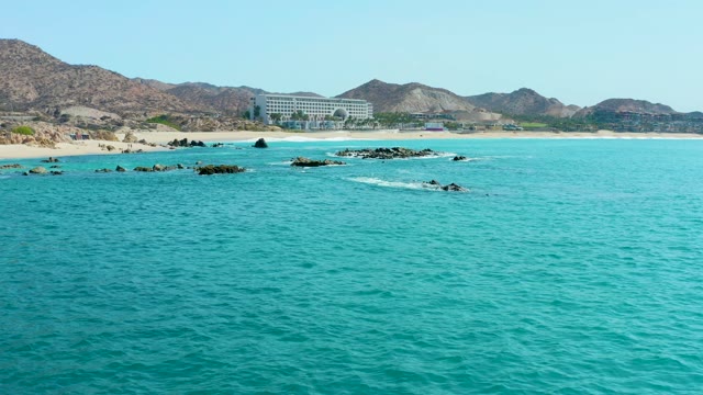 MARQUIS LOS CABOS MEXICO-2021: Ocean Waves Crashing Against Rocky Shoreline