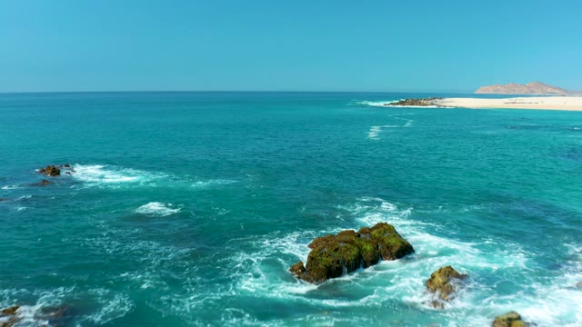 MARQUIS LOS CABOS MEXICO-2021: Waves Hitting Rocky Shore Then Receding to Open Ocean