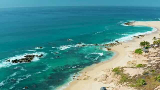 MARQUIS LOS CABOS MEXICO-2021: Waves Breaking on Rocky Coastal Shoreline