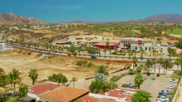 CAMPESTRE SAN JOSE DEL CABO BCS MEXICO-2021: Road Traffic Moving Past Palm Trees and Dry Hills