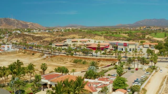 CAMPESTRE SAN JOSE DEL CABO BCS MEXICO-2021: Desert Highway with Moving Traffic and Palm Trees