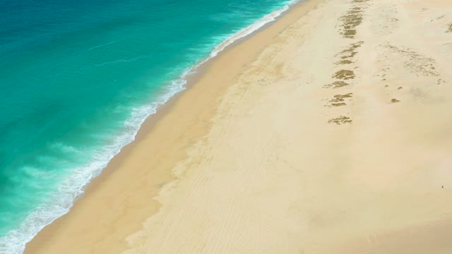 LA LAGUNA BEACH LOS CABOS MEXICO-2021: Gentle Waves Rolling Onto Sandy Beach