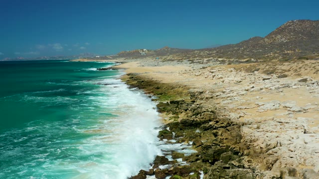 LA LAGUNA BEACH LOS CABOS MEXICO-2021: Ocean Waves Crashing on Rocky Shoreline
