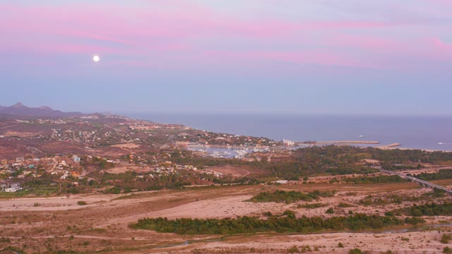 SAN JOSE DEL CABO MEXICO-2021: Coastal Hills Under Moonlit Pink Sky with Moving Clouds