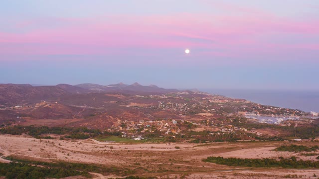 SAN JOSE DEL CABO MEXICO-2021: Hillside Town with Pink Sky and Moon