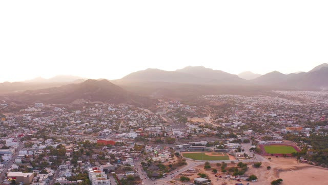 SAN JOSE DEL CABO MEXICO-2021: Urban Neighborhood with Mountain Backdrop and Green Field