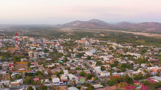 SAN JOSE DEL CABO MEXICO-2021: Residential Area with Red-White Tower and Mountain Backdrop