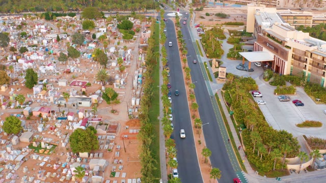 SAN JOSE DEL CABO MEXICO-2021: Moving Vehicles on Road Beside Residential Settlement