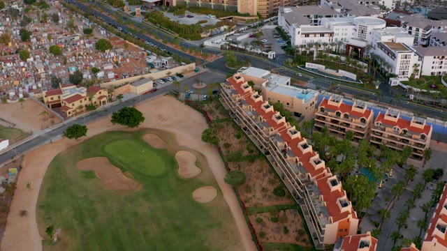 SAN JOSE DEL CABO MEXICO-2021: Golf Course Surrounded by Apartment Buildings and Roads