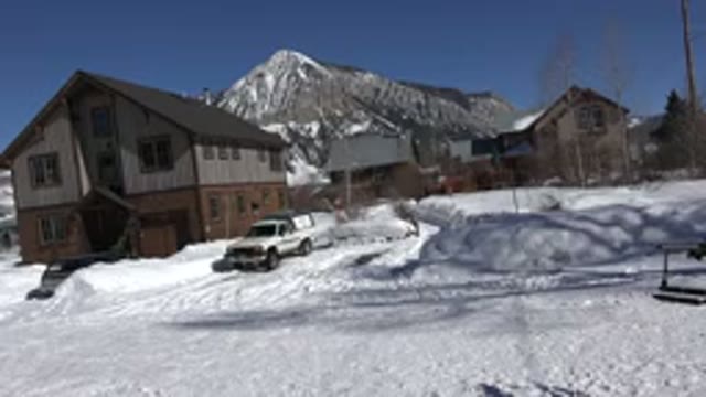 CRESTED BUTTE COLORADO-2015: A House and Car on Street Covered With White Snow