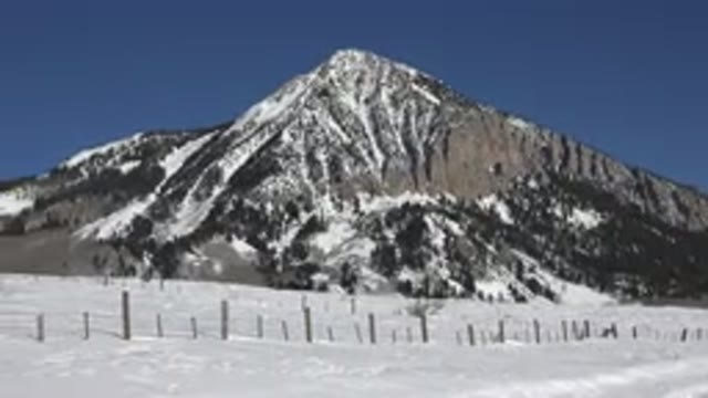 CRESTED BUTTE COLORADO-2015: Mountain With Pine Trees And Snow On The Ground