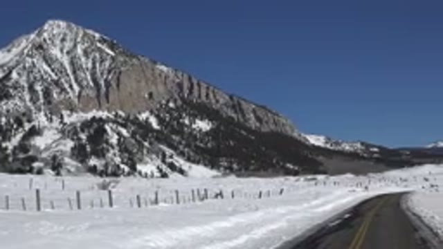 CRESTED BUTTE COLORADO-2015: A Small Road Surrounded By Snow On The Side Of A