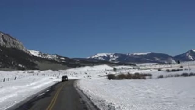 CRESTED BUTTE COLORADO-2015: Snow Covered Mountains Field And Blue Sky On A