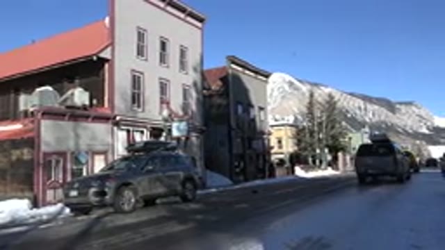 CRESTED BUTTE COLORADO-2015: A Vehicle Moving On A Road And People Standing By