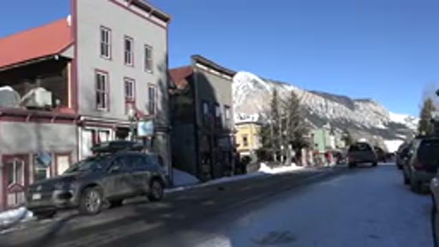CRESTED BUTTE COLORADO-2015: A Vehicle Moving On A Road And People Standing