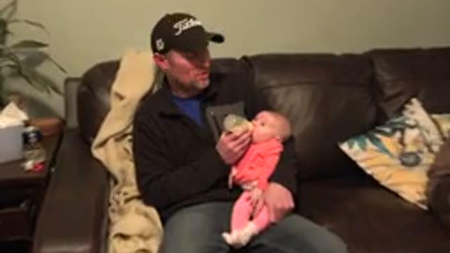 WESTMINSTER COLORADO-2015: Dad Feeds Cute Baby Milk In Bottle While On Sofa