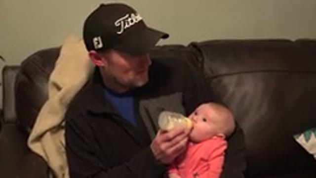 WESTMINSTER COLORADO-2015: Father Sitting With His Baby On His Lap On A Sofa