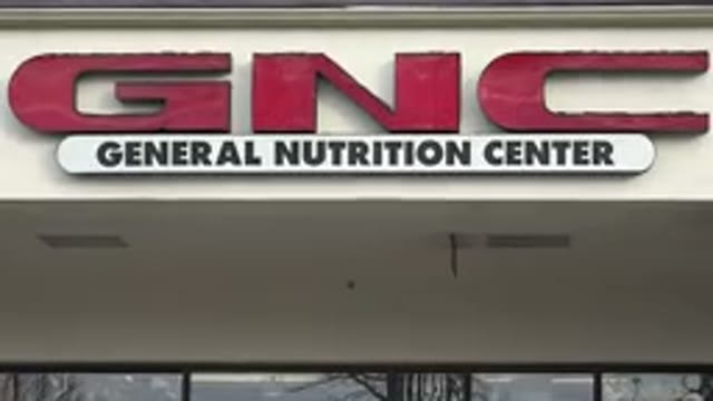WESTMINSTER COLORADO-2015: General Nutrition Center Entrance Sign in Red Glued