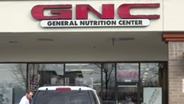 WESTMINSTER COLORADO-2015: View Outside Of A General Nutrition Center With A Car