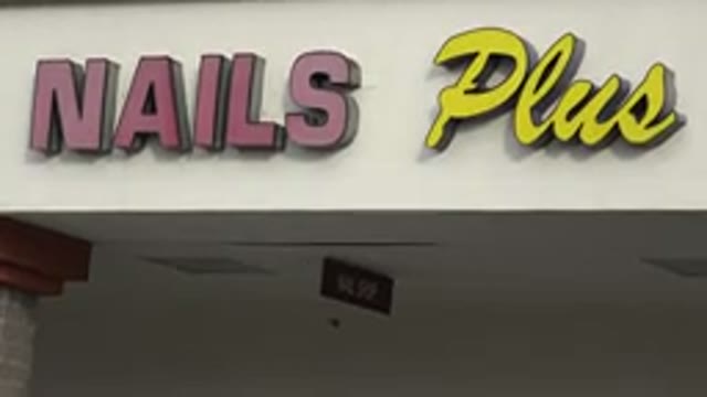 WESTMINSTER COLORADO-2015: Red And Yellow Lettered Nails Plus Sign On A Clear Day