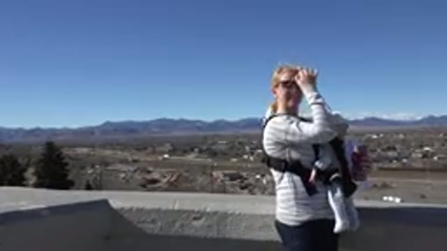 WESTMINSTER COLORADO-2015: A Blond Woman Wearing Sunglasses Holding A Baby Wave