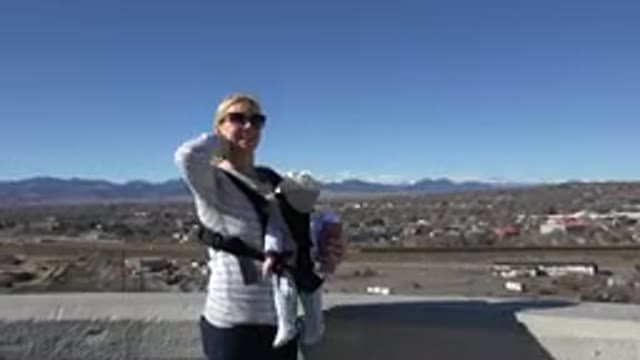 WESTMINSTER COLORADO-2015: Blonde Mother With Baby Strapped To Front In Front Of Mountains