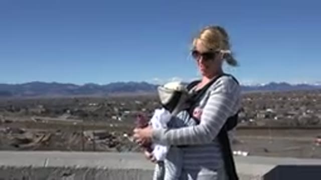 WESTMINSTER COLORADO-2015: Blonde Woman Holding A Baby In A Front Carrier In The Mountains