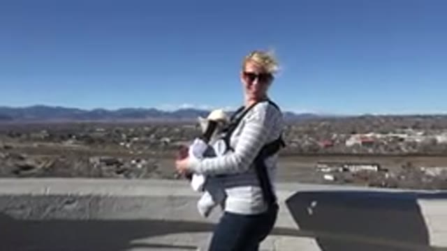 WESTMINSTER COLORADO-2015: Woman Carrying Her Baby Moving Around