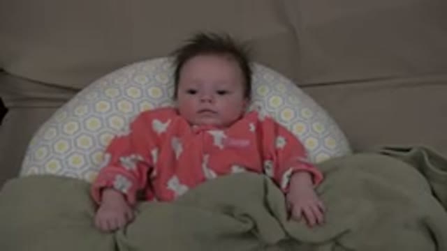 WESTMINSTER COLORADO-2015: Alert Infant Lying On Pillow With Blanket Draped On