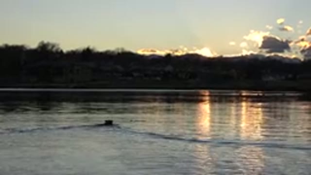 WESTMINSTER COLORADO-2015: A Sunset Over Water With a Mountain and the Sun Setting