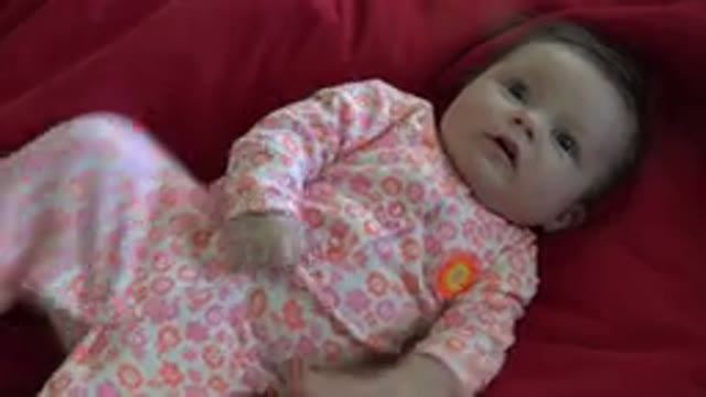 WESTMINSTER COLORADO-2015: Restless Baby Lying On The Bed Moving His Arms And