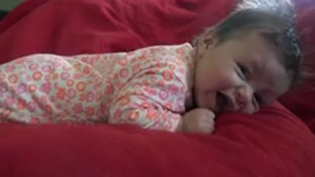 WESTMINSTER COLORADO-2015: Baby Lying Alone On Red Sofa Moving Sideways