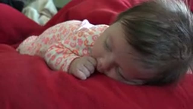 WESTMINSTER COLORADO-2015: Small Child Lying On The Bed Sucking Its Thumb