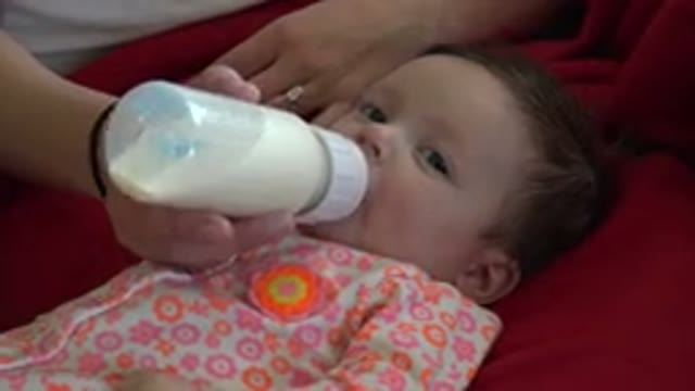WESTMINSTER COLORADO-2015: Hungry Baby Drinking Milk From Bottle