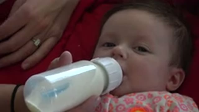WESTMINSTER COLORADO-2015: Mom Feeds Her Baby With Milk From A Baby Bottle