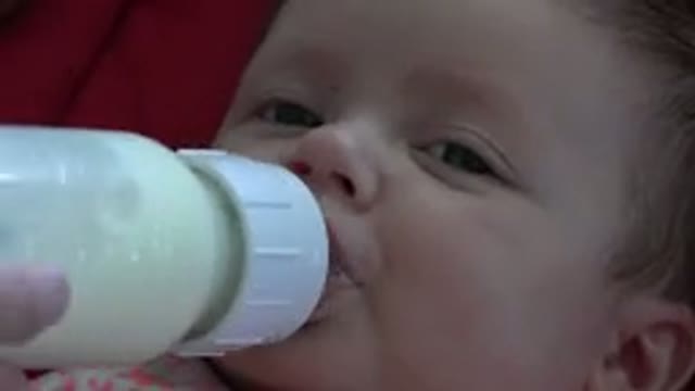 WESTMINSTER COLORADO-2015: New Born Child Drinking Baby Bottle In One Of His
