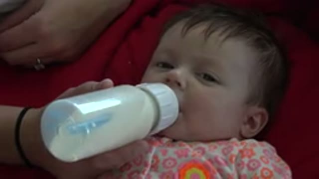 WESTMINSTER COLORADO-2015: Baby Lying On Red Blanket Is Fed With Clear Bottle By