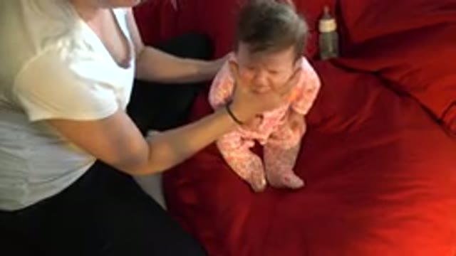 WESTMINSTER COLORADO-2015: Person Wearing White Shirt Helps Baby Wearing Pink