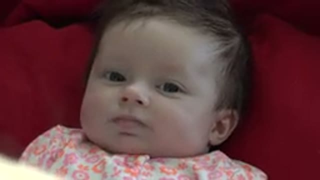 WESTMINSTER COLORADO-2015: Person Looking At Baby Lying On Bed Moving Shaking