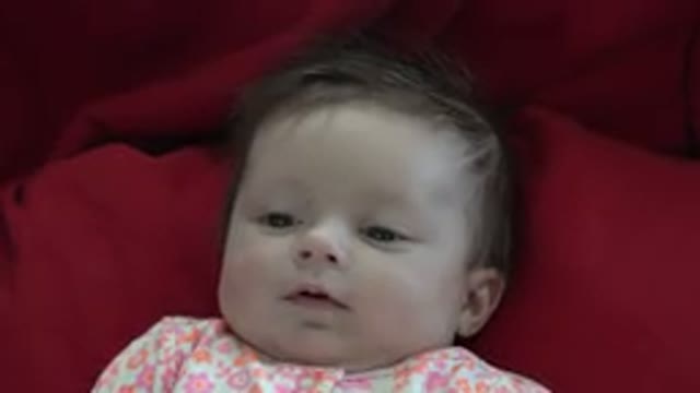 WESTMINSTER COLORADO-2015: Baby Smiling and Cooing to Someone Behind the Camera