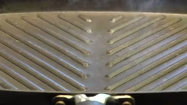 WESTMINSTER COLORADO-2015: Off Screen Person Places Meat On Smoking Gray Grill