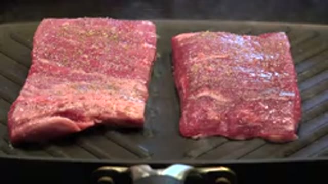 WESTMINSTER COLORADO-2015: Off Screen Person Sprinkles Seasonings on Steaks
