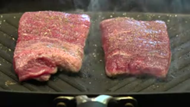 WESTMINSTER COLORADO-2015: A Piece Of Steaming Meat Being Cooked On A Grill