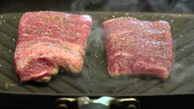 WESTMINSTER COLORADO-2015: Seasoned Skirt Steaks Cooking On Gray Indoor Grill