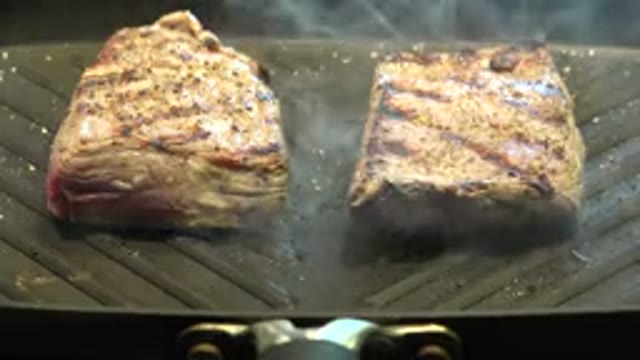 WESTMINSTER COLORADO-2015: Two Large Seasoned Pieces Of Meat Being Roasted On