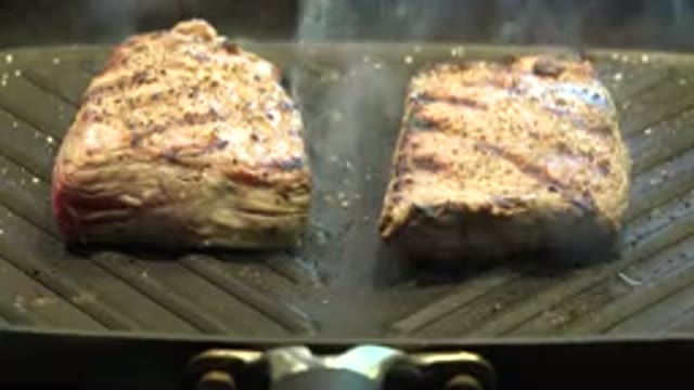 WESTMINSTER COLORADO-2015: Two Large Slabs Of Chicken Are Cooked On A Grill