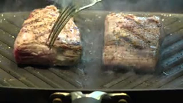 WESTMINSTER COLORADO-2015: Meat Being Grilled And Flipped On A Flat Topped Grill