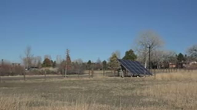 ARVADA COLORADO-2015: A Large Solar Panel In A Dry Winter Field With Several