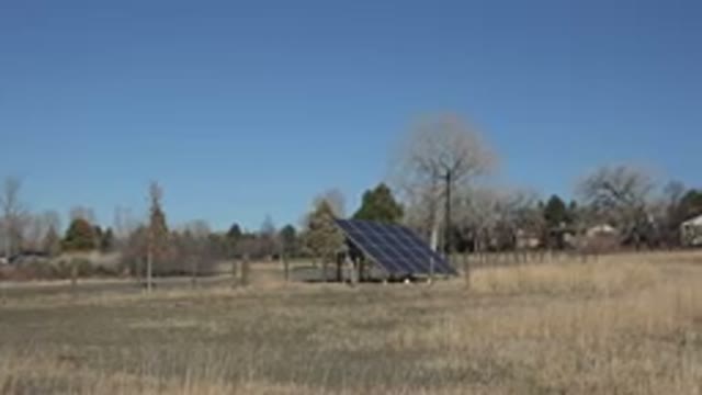 ARVADA COLORADO-2015: Solar Energy Plate in Field of Dirt and Undergrowth